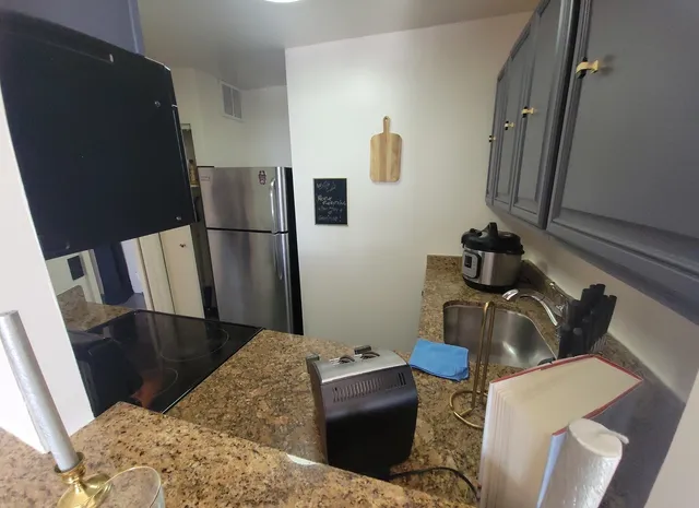 a kitchen with a refrigerator and a stove