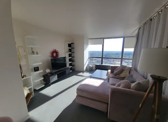 a living room with furniture window and a flat screen tv