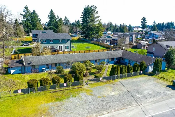a view of a swimming pool with a patio and a yard