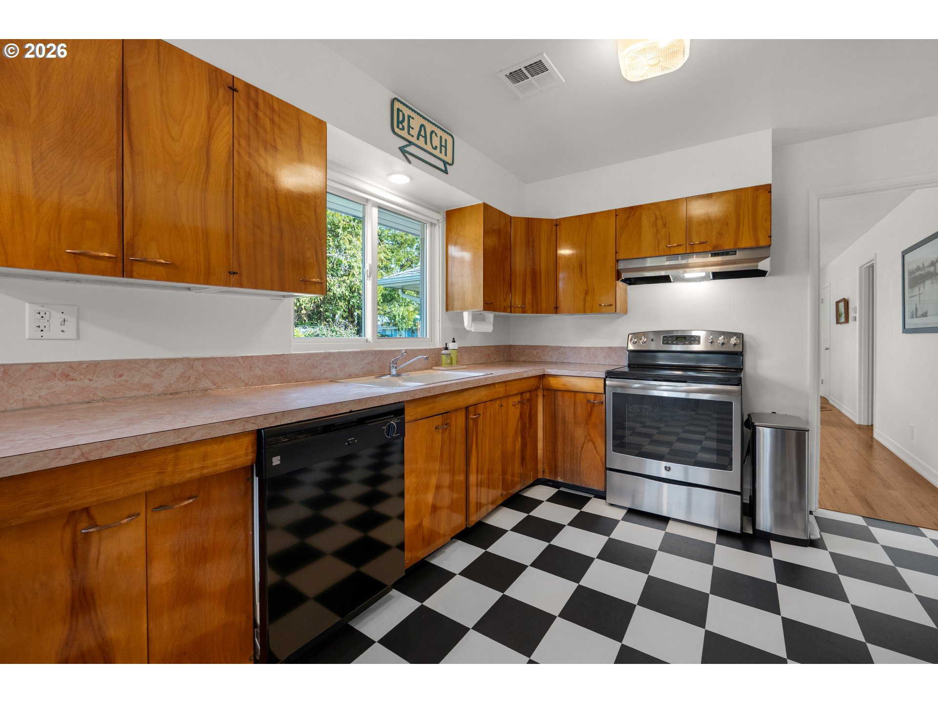 1210 South Columbia Street Seaside, OR 97138 - Photo 12 of 40 a kitchen with a sink a stove cabinets and a window