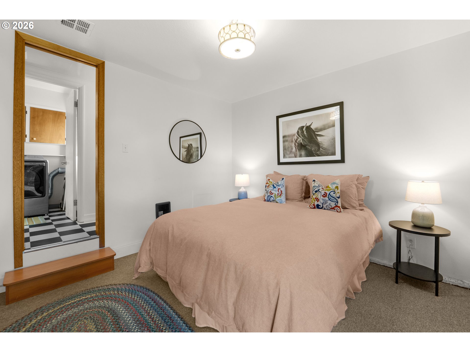 1210 South Columbia Street Seaside, OR 97138 - Photo 24 of 40 a bedroom with a bed and a lamp with wall painting