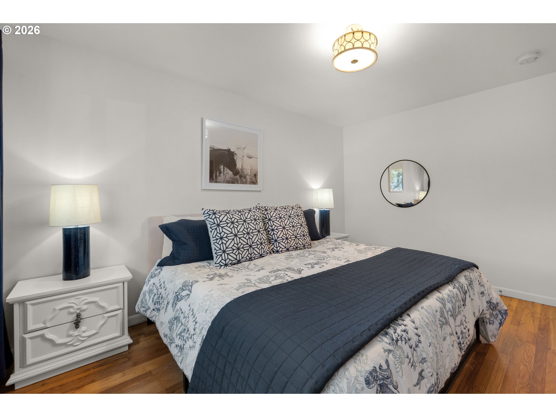 1210 South Columbia Street Seaside, OR 97138 - Photo 27 of 40 a bedroom with a bed and a lamp