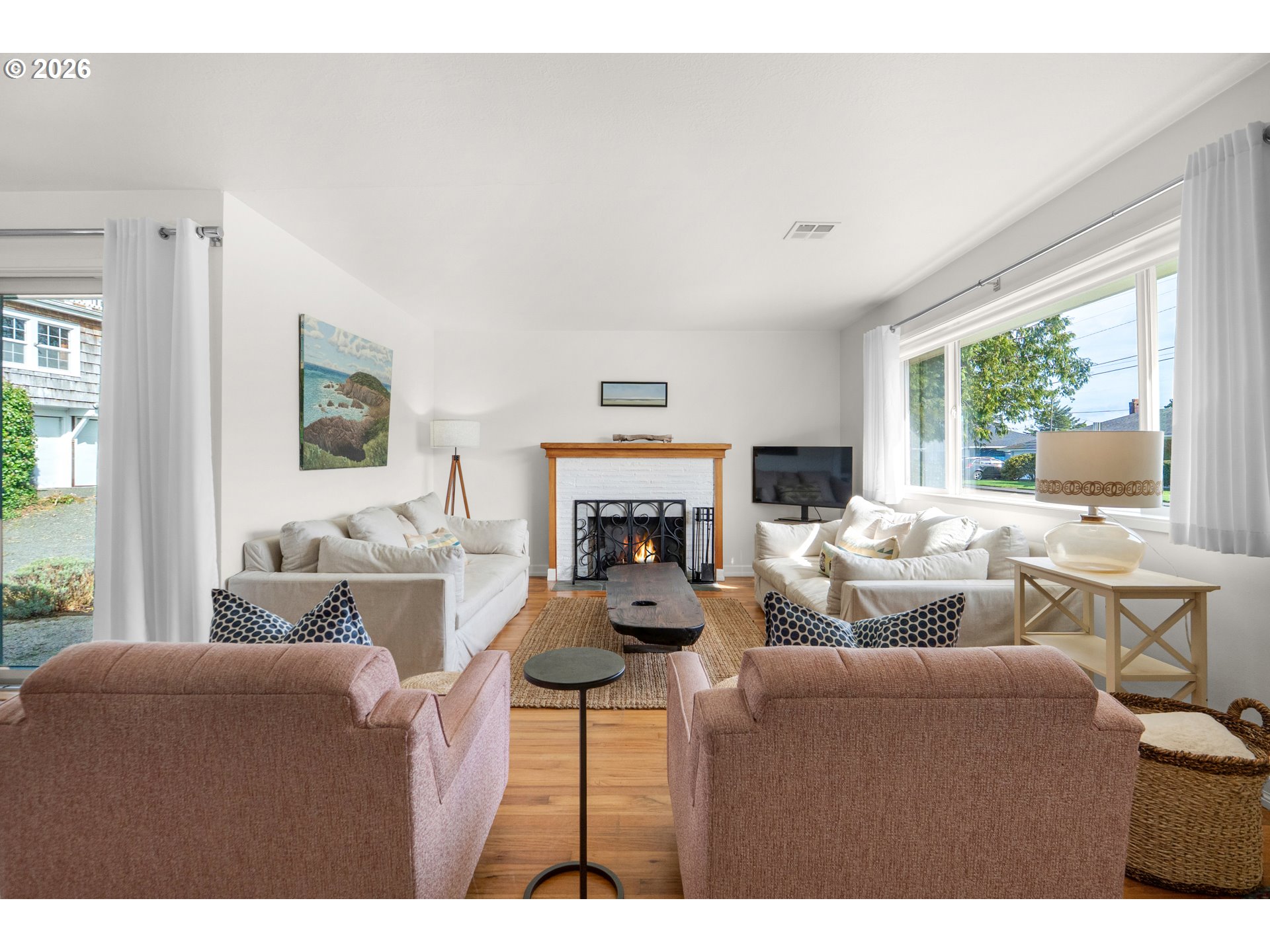 1210 South Columbia Street Seaside, OR 97138 - Photo 6 of 40 a living room with furniture large window and a fireplace
