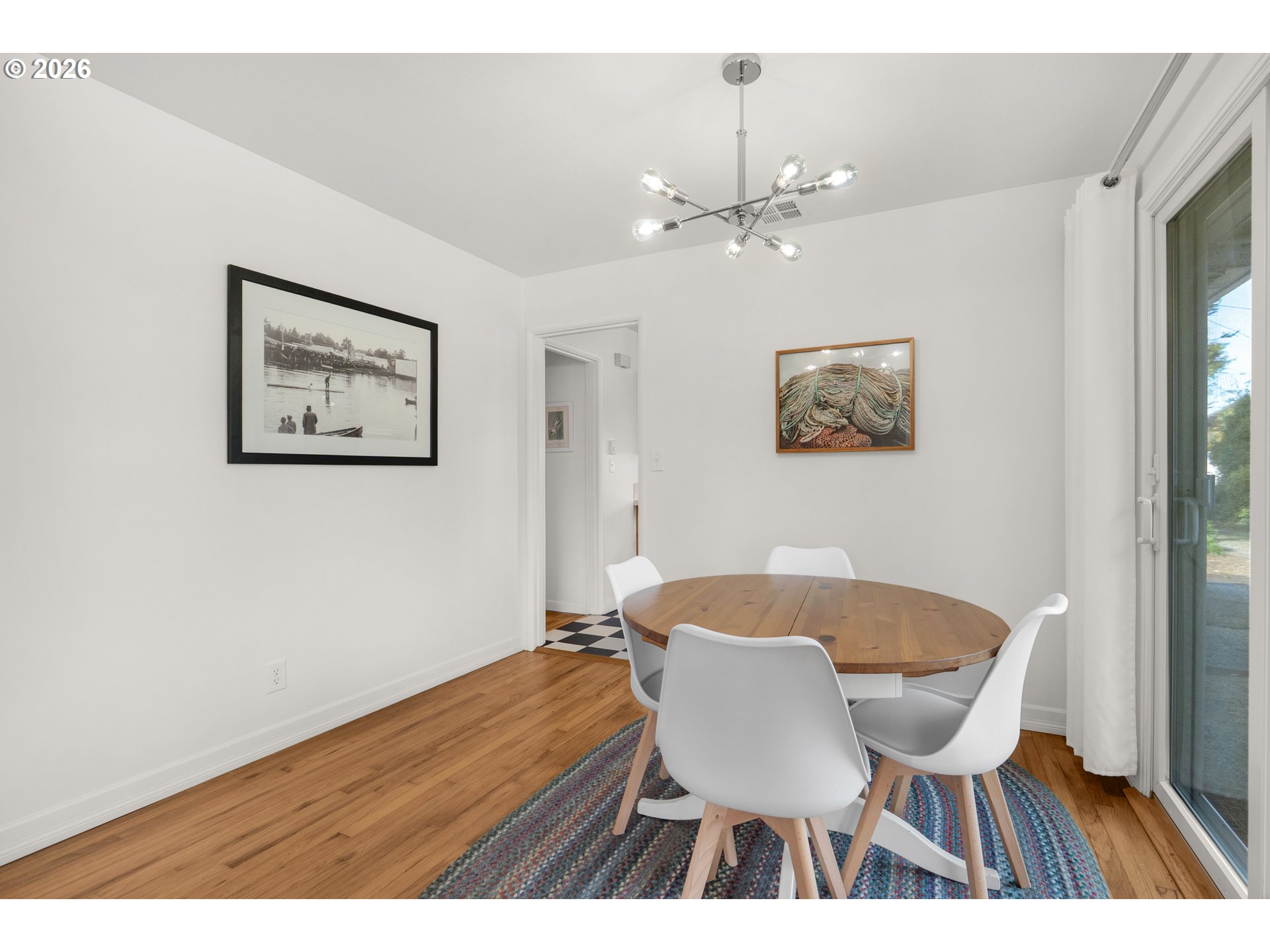 1210 South Columbia Street Seaside, OR 97138 - Photo 10 of 40 a view of a dining room with furniture and wooden floor