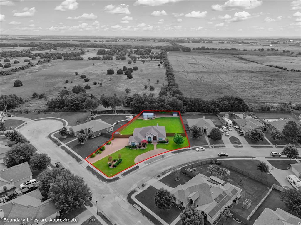 910 Springdale Lane Lorena, TX 76655 - Photo 3 of 39 Expansive corner lot featuring a stucco and brick exterior, a circular driveway, mature landscaping, and an additional detached structure
