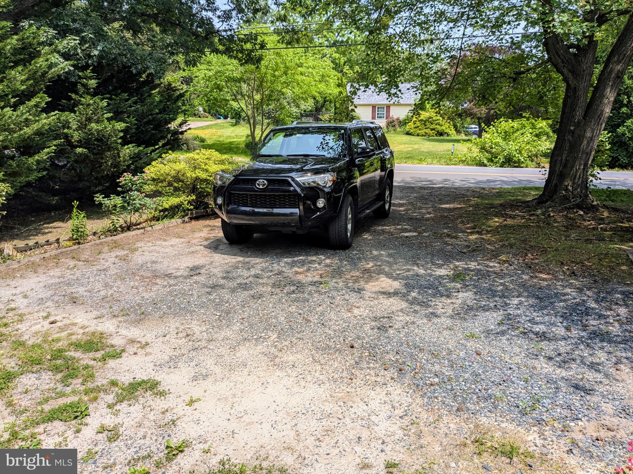 2408 Old Mountain Road Joppa, MD 21085 - Photo 5 of 25 a view of a yard with a car parked