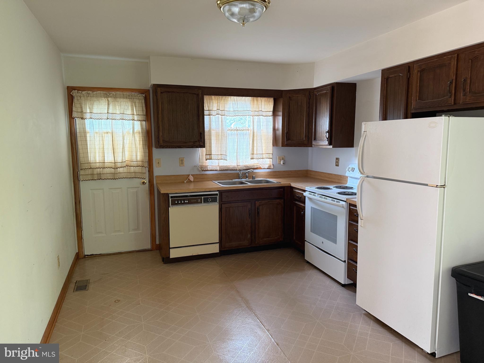 2408 Old Mountain Road Joppa, MD 21085 - Photo 7 of 25 a kitchen with stainless steel appliances granite countertop a refrigerator a sink a stove a microwave and island