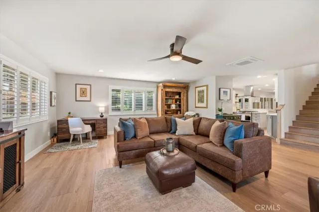 a kitchen with stainless steel appliances kitchen island granite countertop a refrigerator and a sink