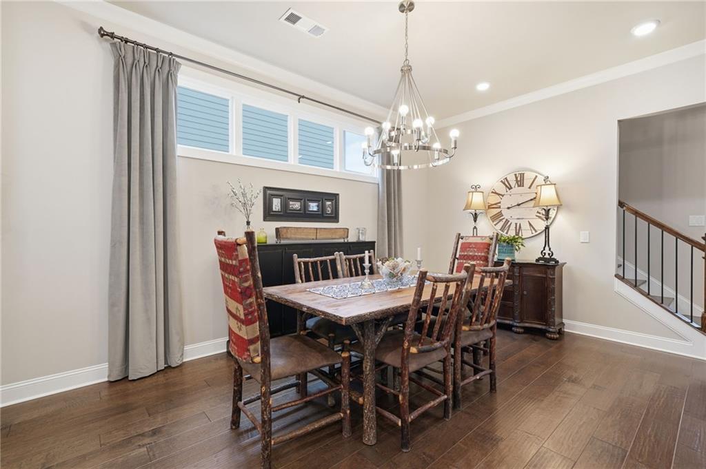 112 Idylwilde Way Canton, GA 30115 - Photo 11 of 46 a dining room with furniture a chandelier and wooden floor