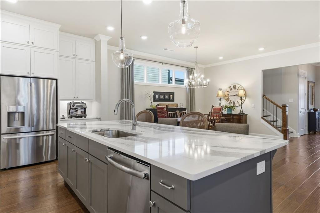 112 Idylwilde Way Canton, GA 30115 - Photo 16 of 46 a kitchen with stainless steel appliances granite countertop a sink refrigerator and cabinets