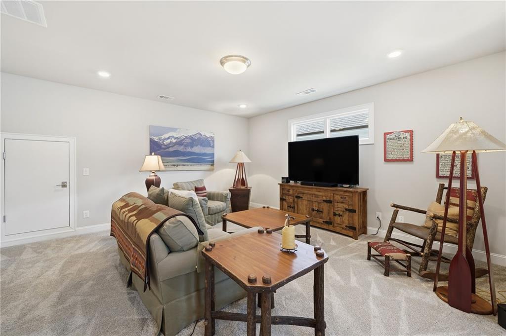112 Idylwilde Way Canton, GA 30115 - Photo 29 of 46 a living room with furniture and a flat screen tv
