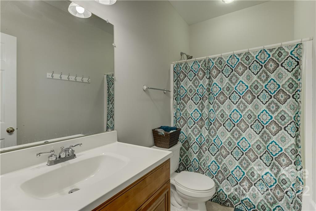 783 Julia Street Fort Mill, SC 29708 - Photo 28 of 48 a bathroom with a sink a toilet and a mirror