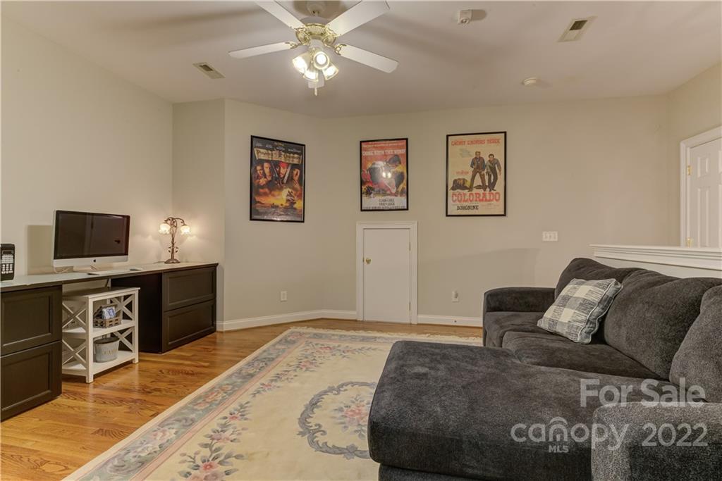 783 Julia Street Fort Mill, SC 29708 - Photo 34 of 48 a spacious bedroom with a bed and a flat screen tv