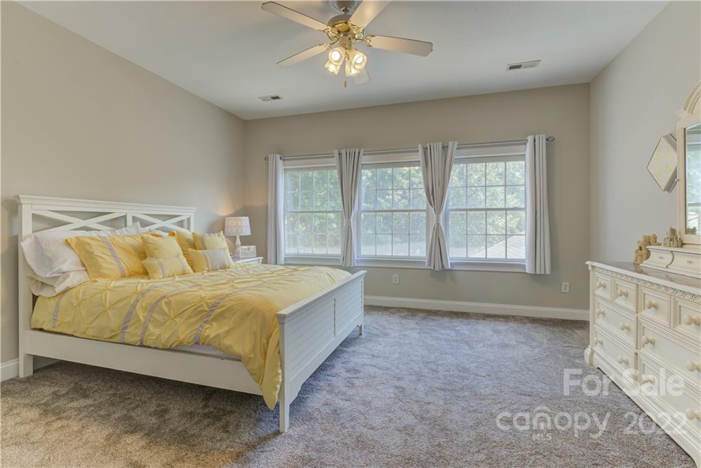 783 Julia Street Fort Mill, SC 29708 - Photo 35 of 48 a spacious bedroom with a bed and a window