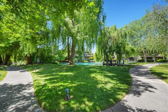 a view of swimming pool with outdoor seating and a garden