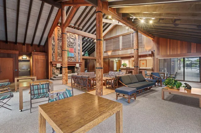 a sitting area with pool table and a rug