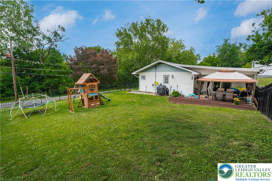 50 Kohls Road Northampton, PA 18067 - Photo 35 of 54 A spacious yard boasts a dedicated play area, offering abundant outdoor recreation.