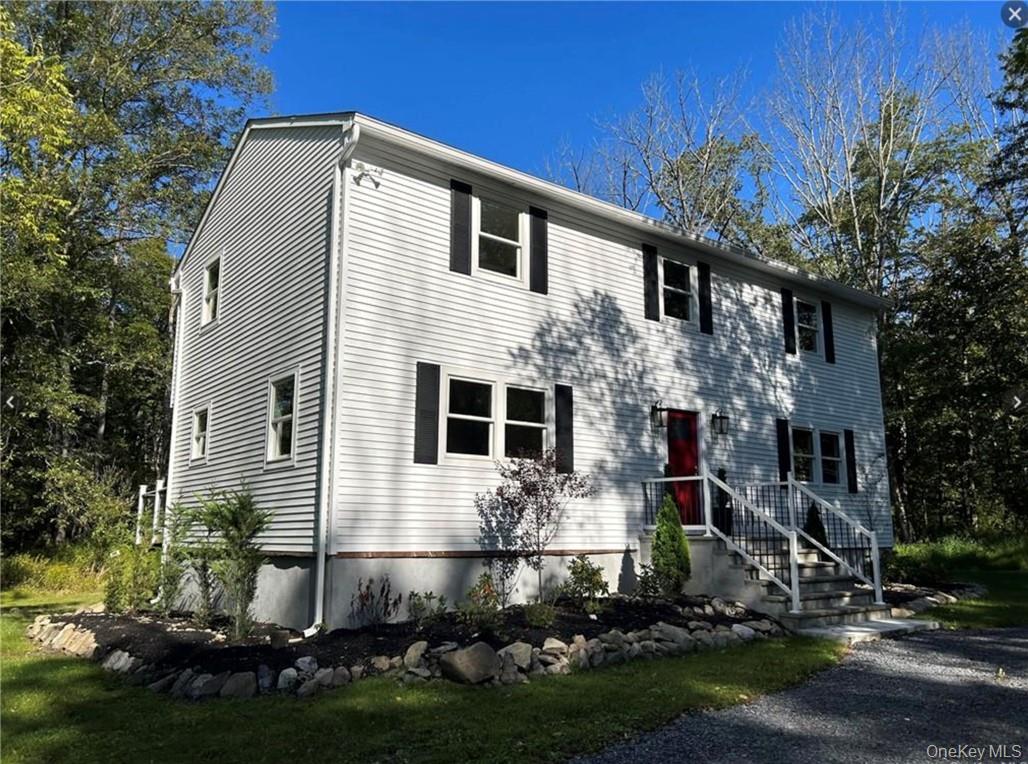 a front view of house with yard and green space