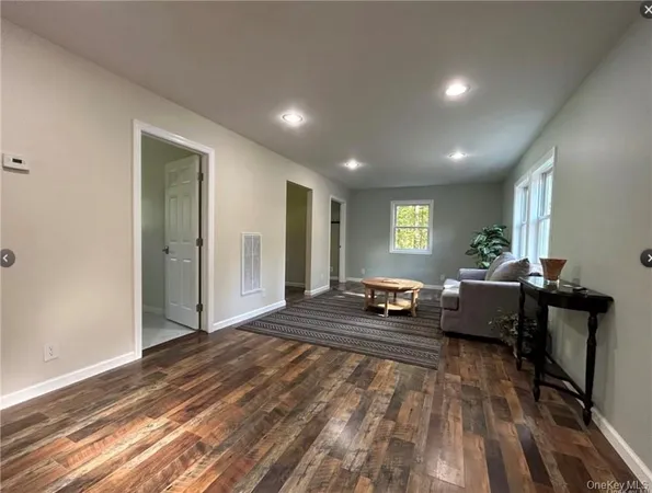 a bedroom with furniture and a wooden floor