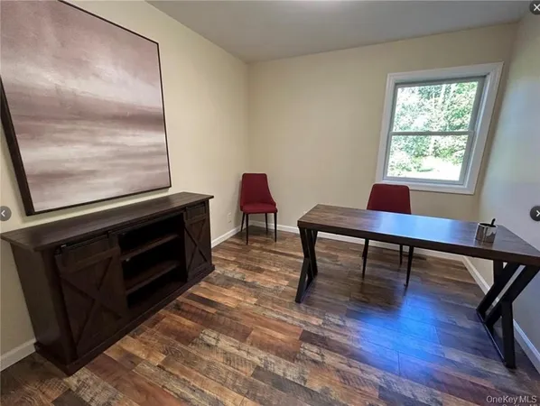 a workspace with furniture window and wooden floor