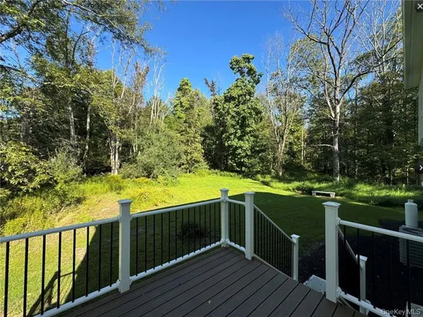 a view of a deck with wooden floor and fence