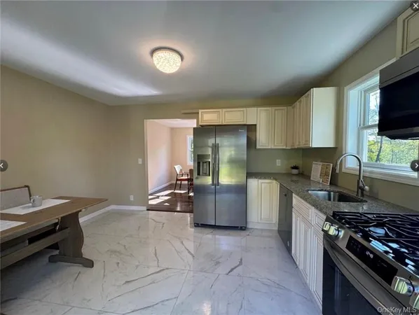 a kitchen with refrigerator and cabinets