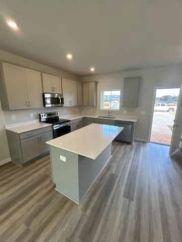 a kitchen with a white stove top oven and white refrigerator