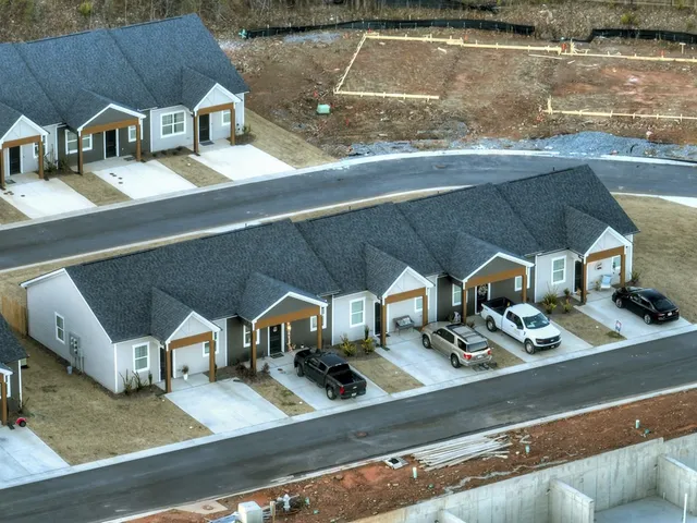 an aerial view of a house with swimming pool and porch