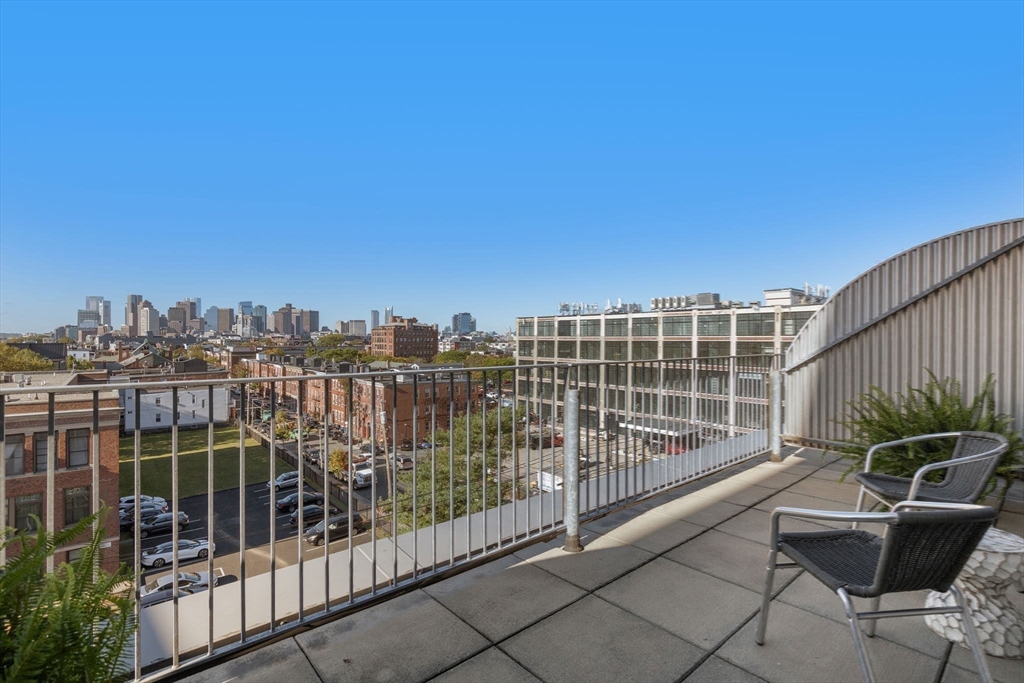 156 Porter Street, Unit 421 Boston, MA 02128 - Photo 20 of 29 a view of roof deck with wooden fence and city view
