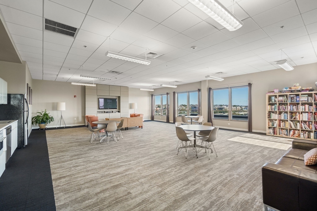 156 Porter Street, Unit 421 Boston, MA 02128 - Photo 23 of 29 a living room with furniture and a table