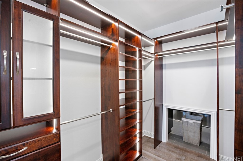 11907 Ancona Way Porter Ranch, CA 91326 - Photo 33 of 67 a view of walk in closet with empty racks
