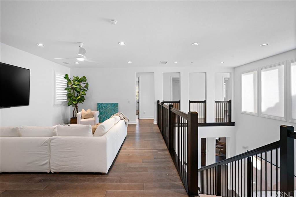 11907 Ancona Way Porter Ranch, CA 91326 - Photo 41 of 67 a living room with furniture kitchen view and a flat screen tv