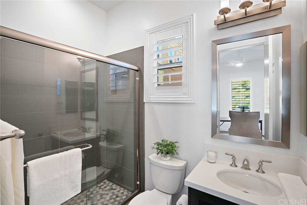11907 Ancona Way Porter Ranch, CA 91326 - Photo 56 of 67 a bathroom with a sink toilet and shower