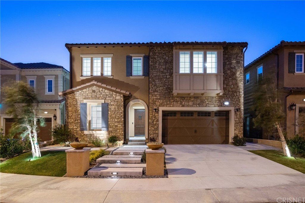 11907 Ancona Way Porter Ranch, CA 91326 - Photo 64 of 67 a front view of a house with a yard