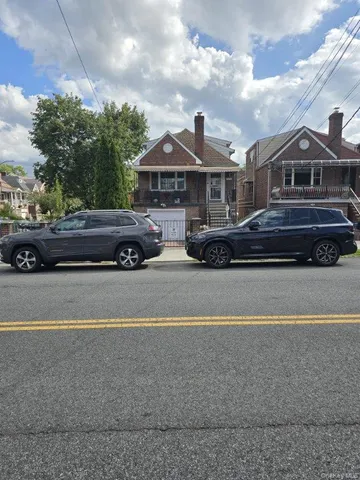 a front view of a house with a parking space