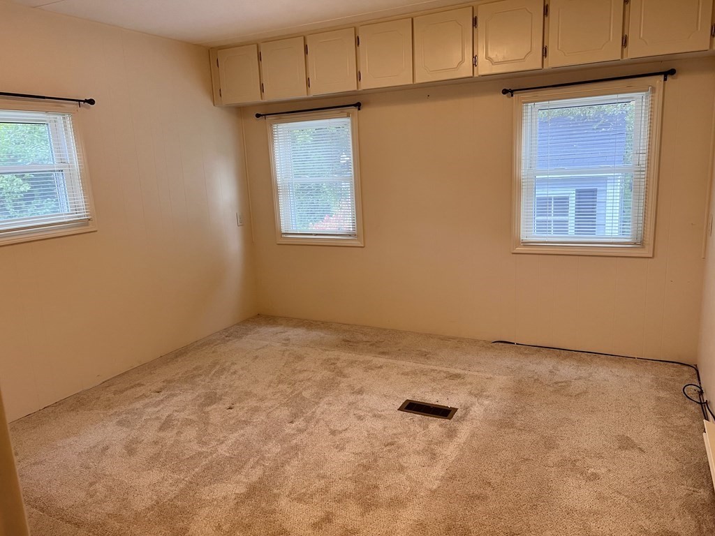 25 St James Circle Hudson, MA 01749 - Photo 13 of 15 a view of an empty room with a window