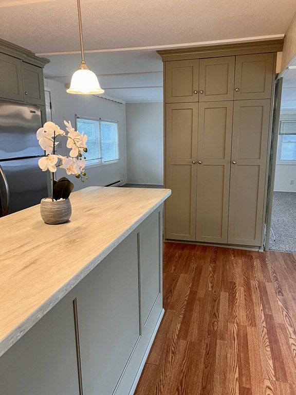 25 St James Circle Hudson, MA 01749 - Photo 6 of 15 a kitchen with a sink and a refrigerator