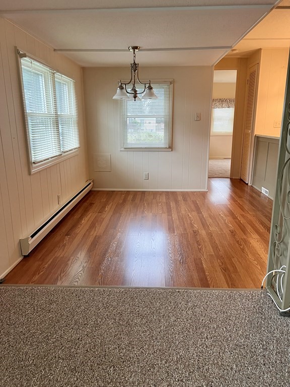 25 St James Circle Hudson, MA 01749 - Photo 7 of 15 an empty room with wooden floor and windows
