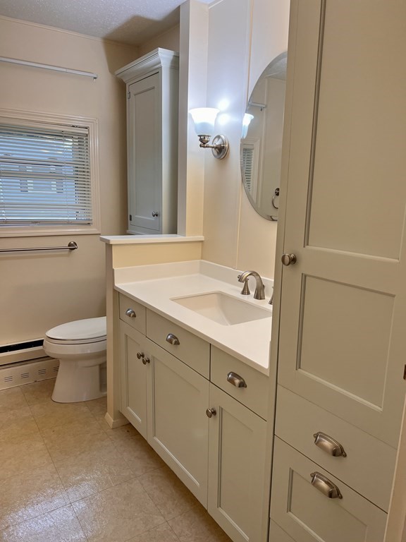 25 St James Circle Hudson, MA 01749 - Photo 9 of 15 a bathroom with a sink a toilet and shower