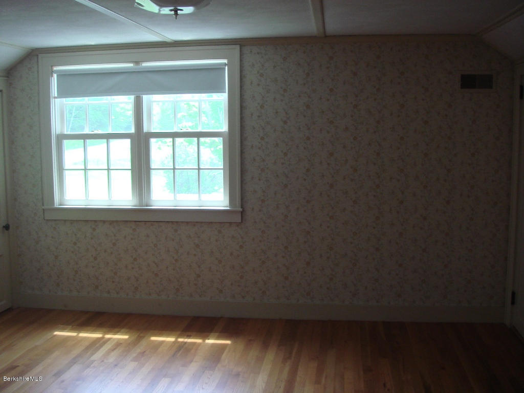 525 E Road Clarksburg, MA 01247 - Photo 14 of 24 an empty room with wooden floor and windows
