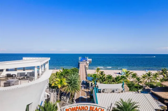 a view of a balcony with chairs potted plants