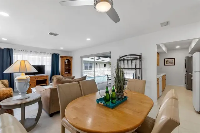 a living room with furniture a dining table and a chandelier