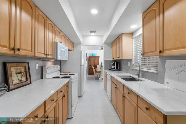 a kitchen with a sink a stove and cabinets