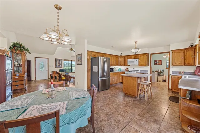 a kitchen with stainless steel appliances granite countertop a refrigerator stove and sink