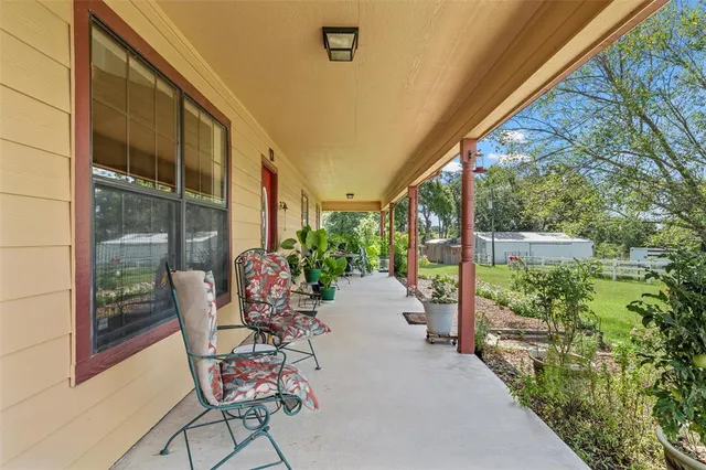 a view of an chairs and table in the balcony