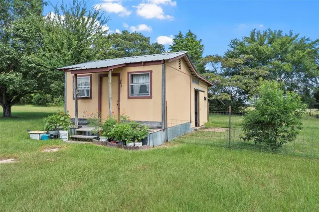 an aerial view of a houses with outdoor space and city view
