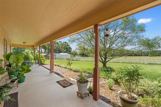 a view of a balcony with lake view and a potted plant
