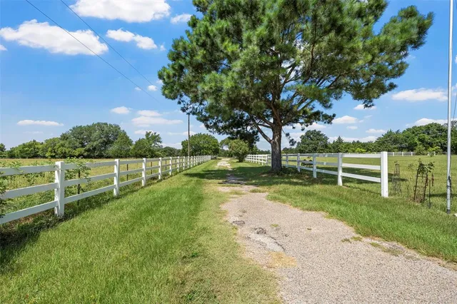 a living room with furniture a chandelier and a window