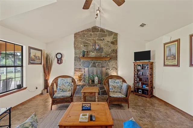 a living room with furniture a rug and a large window