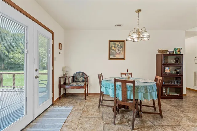 a view of a dining room with furniture and chandelier